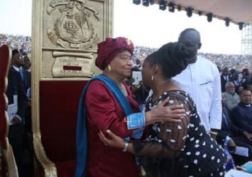 Vice President Taylor embraces outgoing President Sirleaf as President Weah look onExecutive Mansion Photo