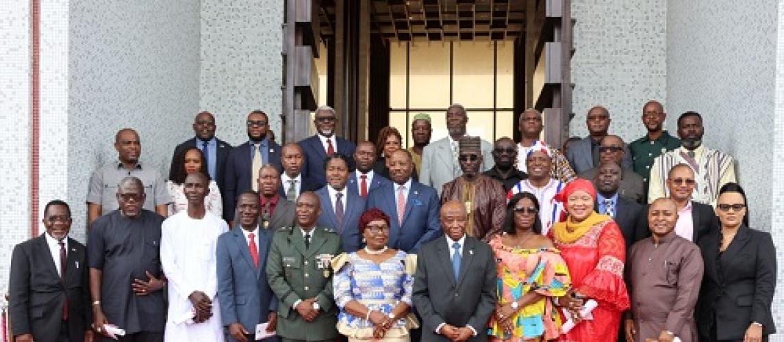 Officials of government pose in a photo with President Boakai